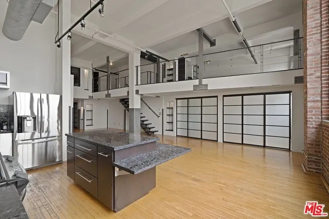 a kitchen with stainless steel appliances granite countertop a refrigerator and a stove