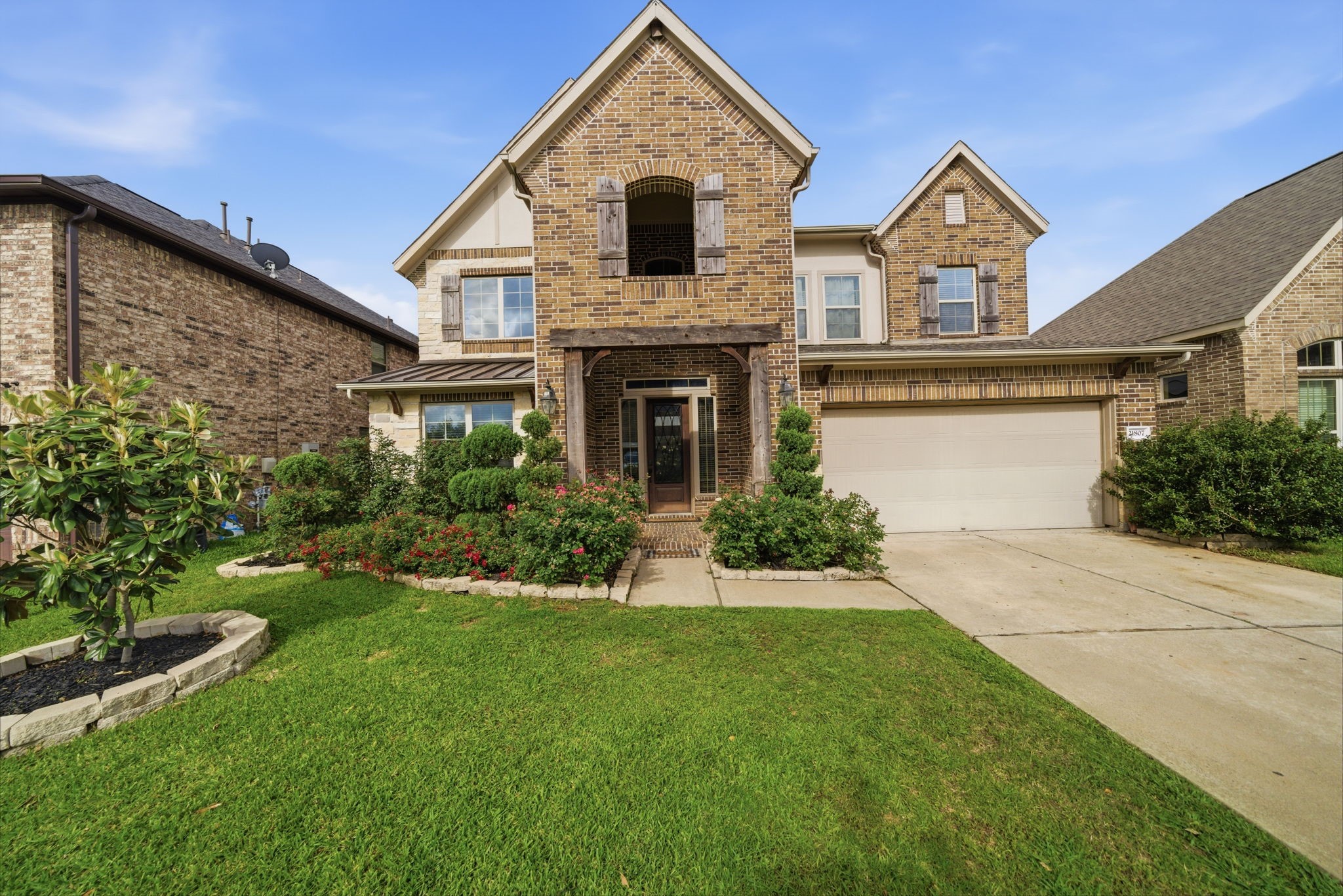 a front view of a house with a yard and garage