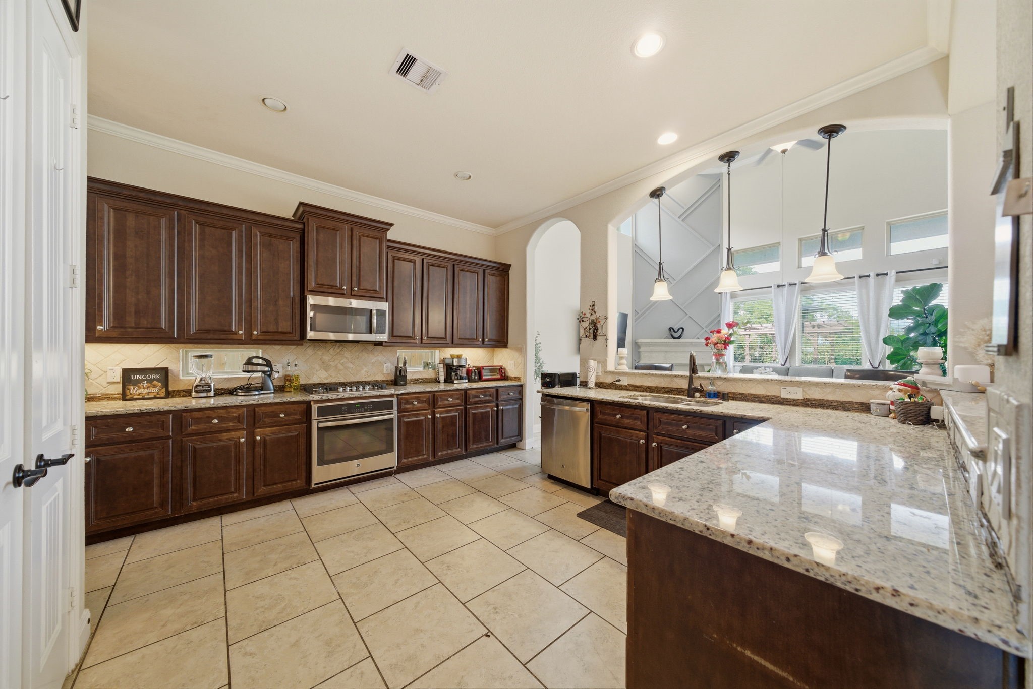 21807 Lozar Drive Spring, TX 77379 - Photo 4 of 20 a kitchen with stainless steel appliances granite countertop a sink counter space cabinets and a large window