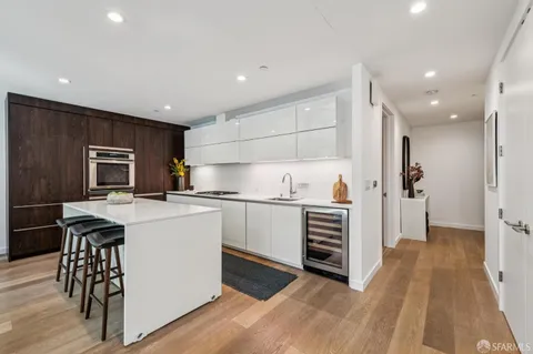 a kitchen with a refrigerator and a stove top oven
