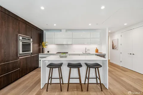 a kitchen with kitchen island a stove and a refrigerator