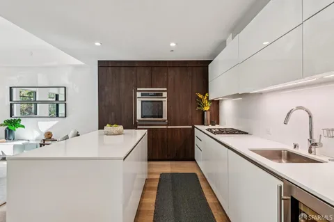 a kitchen with a sink stove and refrigerator