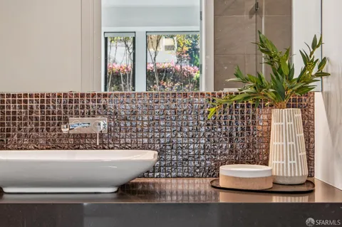 a spacious bedroom with a bed a couch and a window