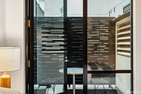 a view of a chairs and table in the balcony
