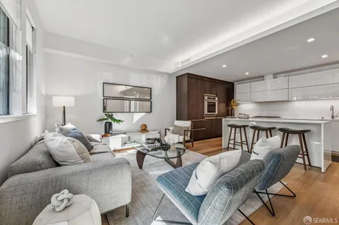 a living room with furniture and kitchen view