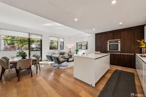 a living room with furniture wooden floor and a table