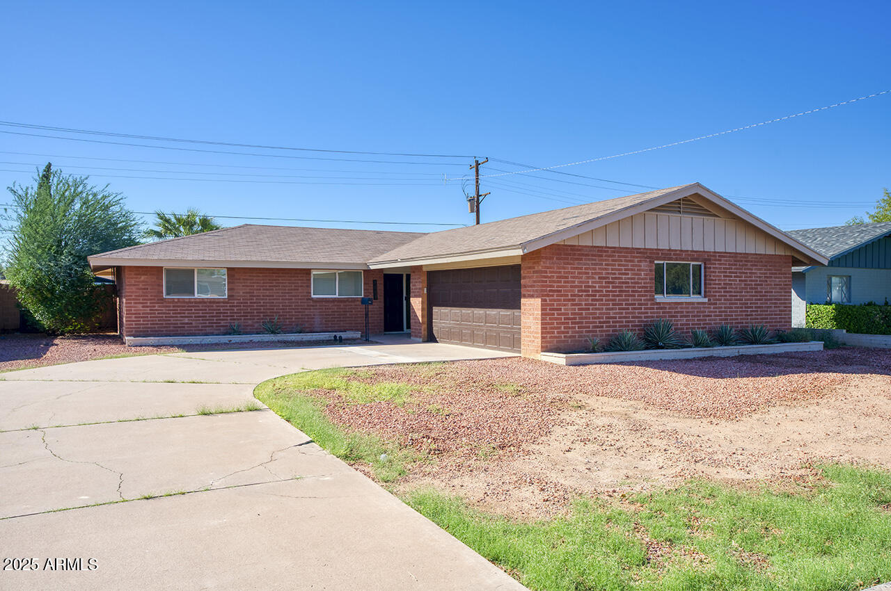 1881 East Concorda Drive Tempe, AZ 85282 - Photo 1 of 15 a front view of a house with a garden