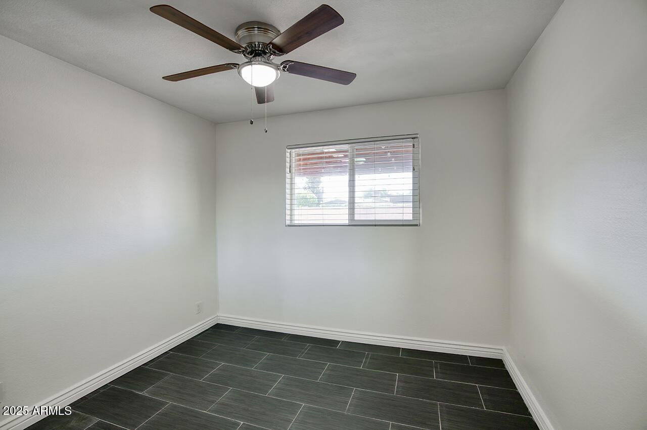 1881 East Concorda Drive Tempe, AZ 85282 - Photo 13 of 15 an empty room with a window and a fan
