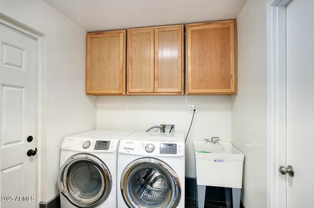 a view of storage and utility room with washer and dryer