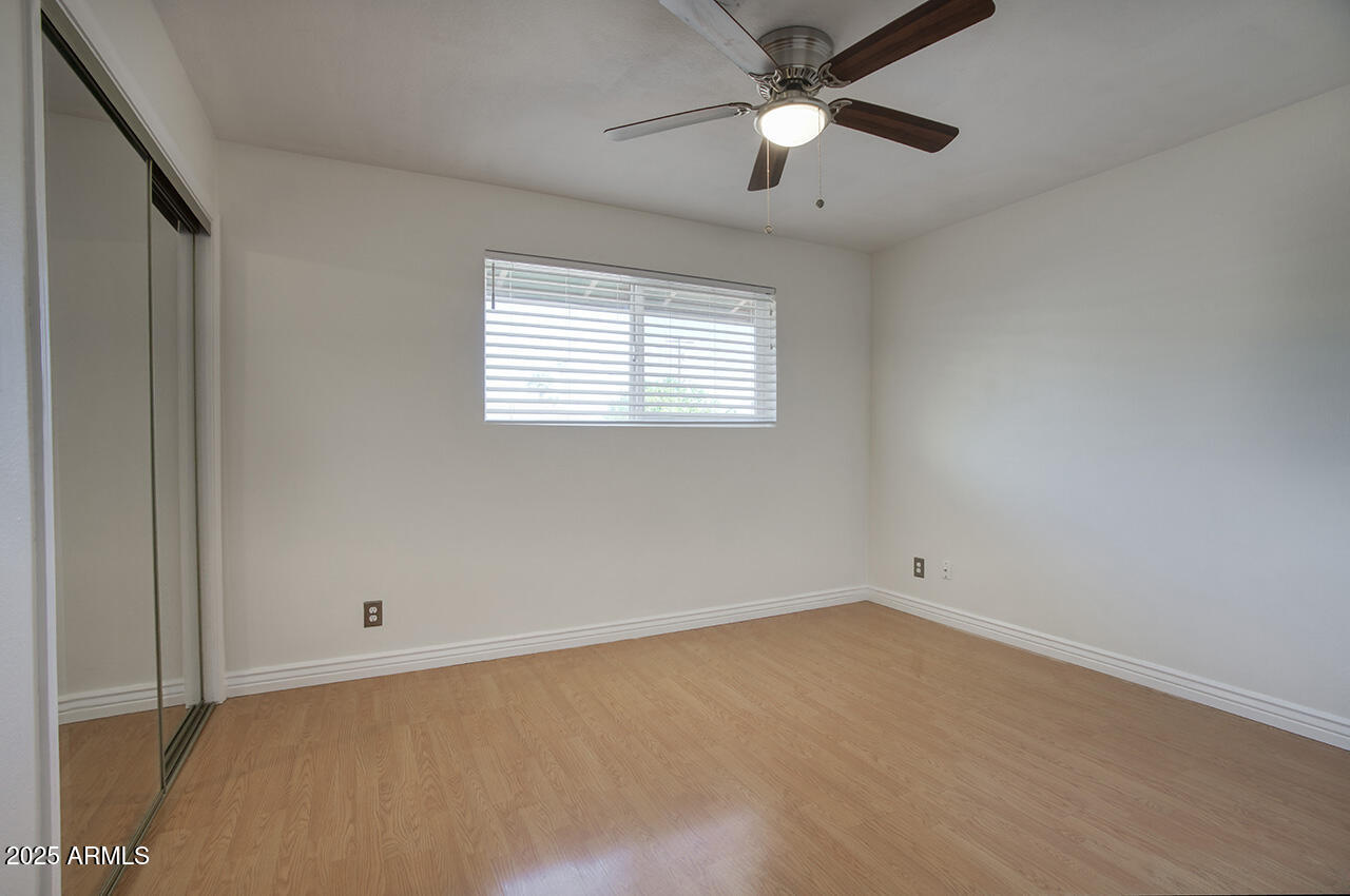 1881 East Concorda Drive Tempe, AZ 85282 - Photo 10 of 15 an empty room with a window and a fan