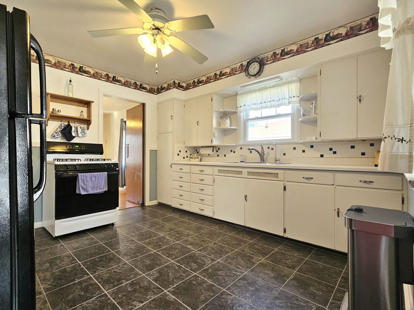 122 South Park Road Joliet, IL 60433 - Photo 5 of 19 a kitchen with a stove a sink and a refrigerator