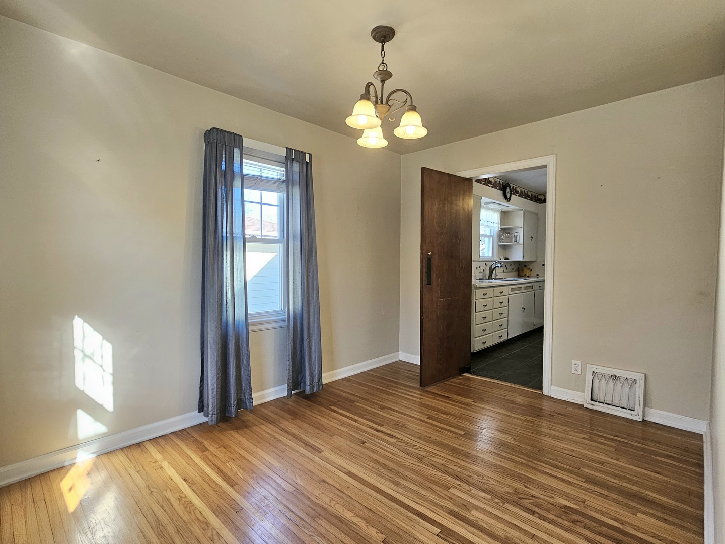 122 South Park Road Joliet, IL 60433 - Photo 8 of 19 a view of an empty room with wooden floor and a window