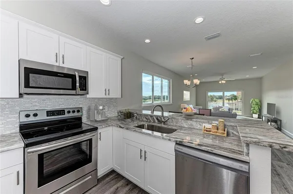 a kitchen with a sink stove and microwave