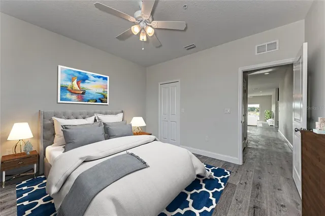 a bedroom with bed and a chandelier