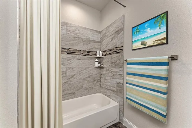 a bathroom with a bathtub and a shower