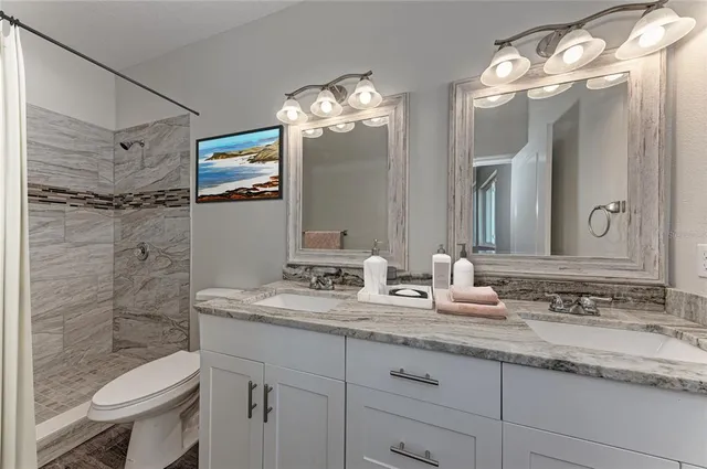 a bathroom with a sink double vanity and a mirror
