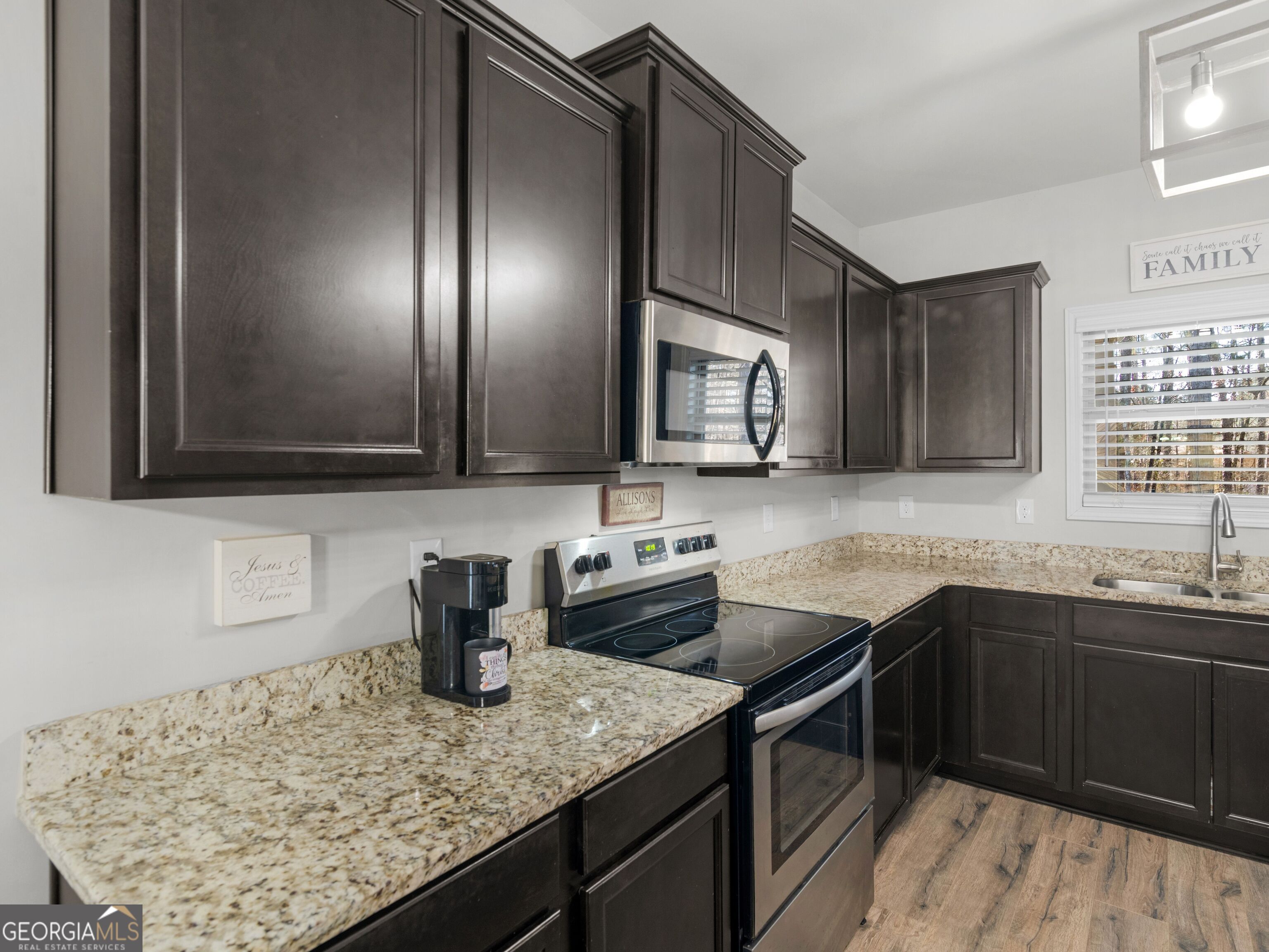 57 Partridge Court Monticello, GA 31064 - Photo 19 of 47 a kitchen with stainless steel appliances granite countertop a sink stove and cabinets