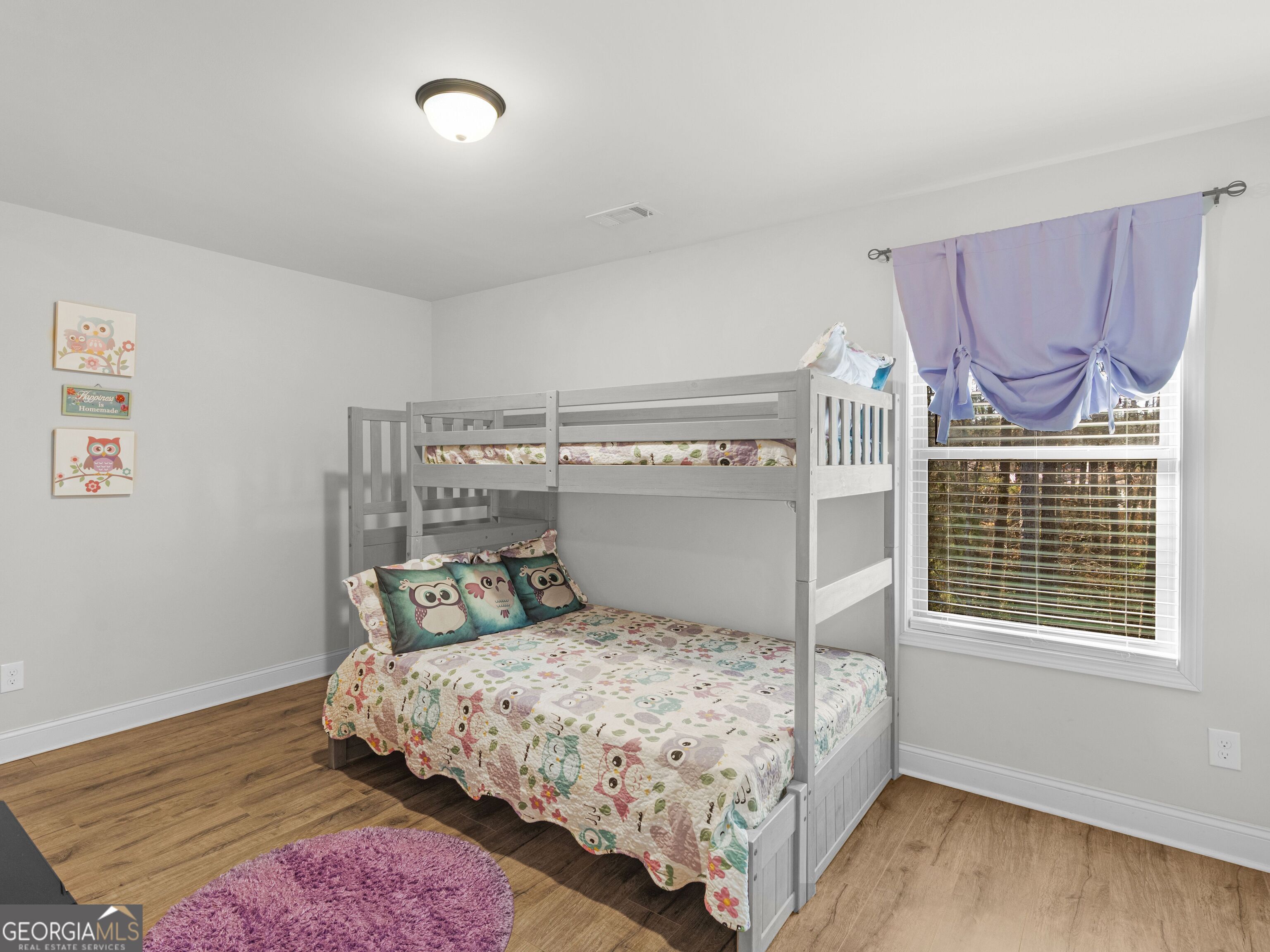 57 Partridge Court Monticello, GA 31064 - Photo 29 of 47 a bedroom with a bed and wooden floor