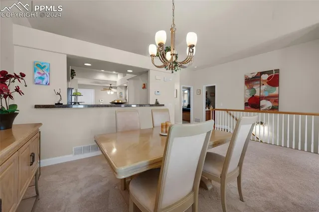 a view of a dining room with furniture and chandelier
