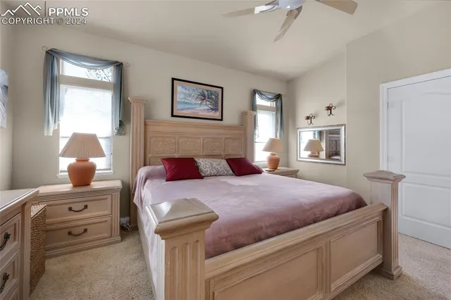a bathroom with a granite countertop sink a large mirror and a bathtub