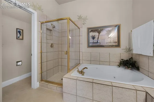 a view of a kitchen with stainless steel appliances granite countertop a refrigerator a sink dishwasher and wooden cabinets with wooden floor