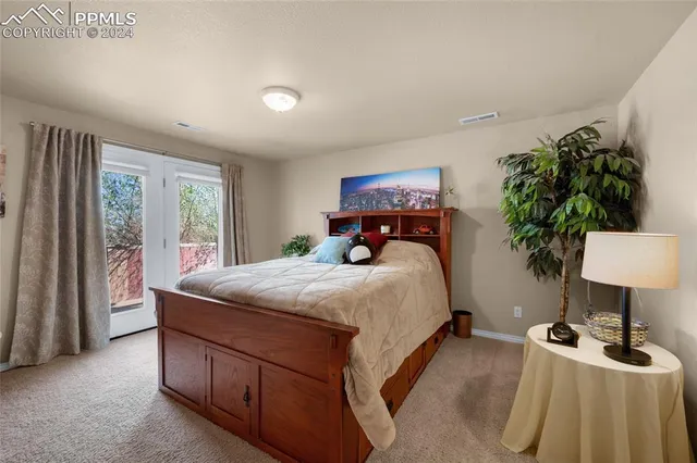 a bedroom with a bed and a chair