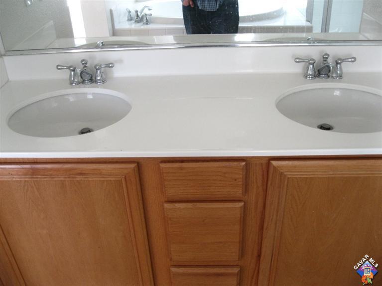 2506 Rabbit Ridge Court Palmdale, CA 93550 - Photo 12 of 15 a bathroom with a sink and a large mirror