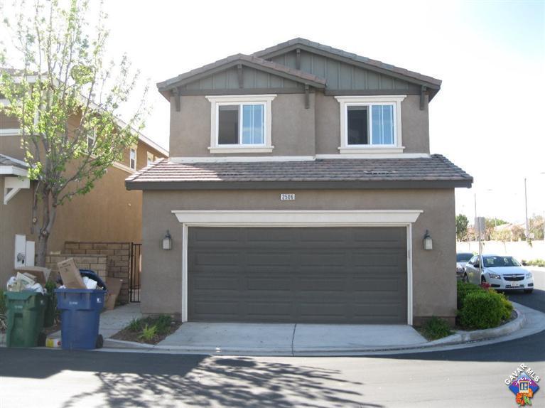 2506 Rabbit Ridge Court Palmdale, CA 93550 - Photo 4 of 15 a front view of a house with garden