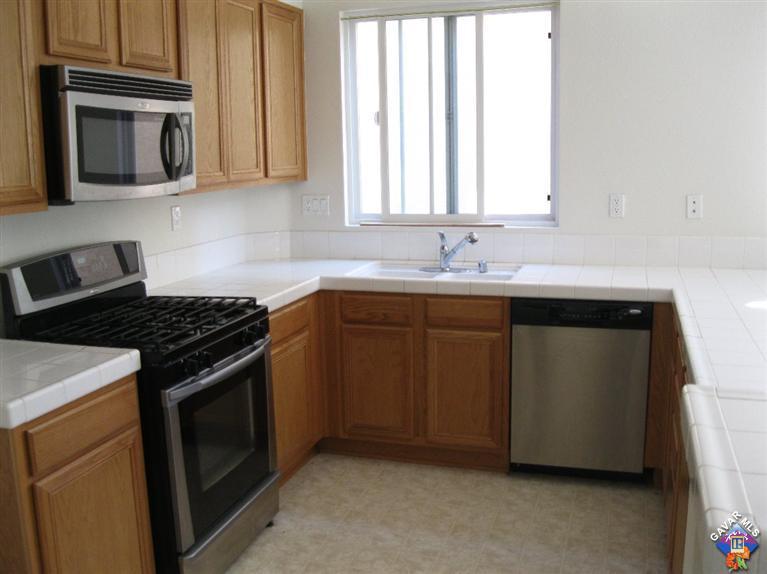 2506 Rabbit Ridge Court Palmdale, CA 93550 - Photo 6 of 15 a kitchen with a stove and a microwave