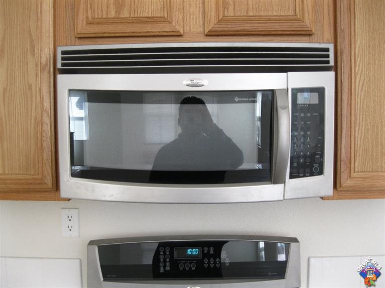 2506 Rabbit Ridge Court Palmdale, CA 93550 - Photo 9 of 15 a kitchen with a stove and a microwave