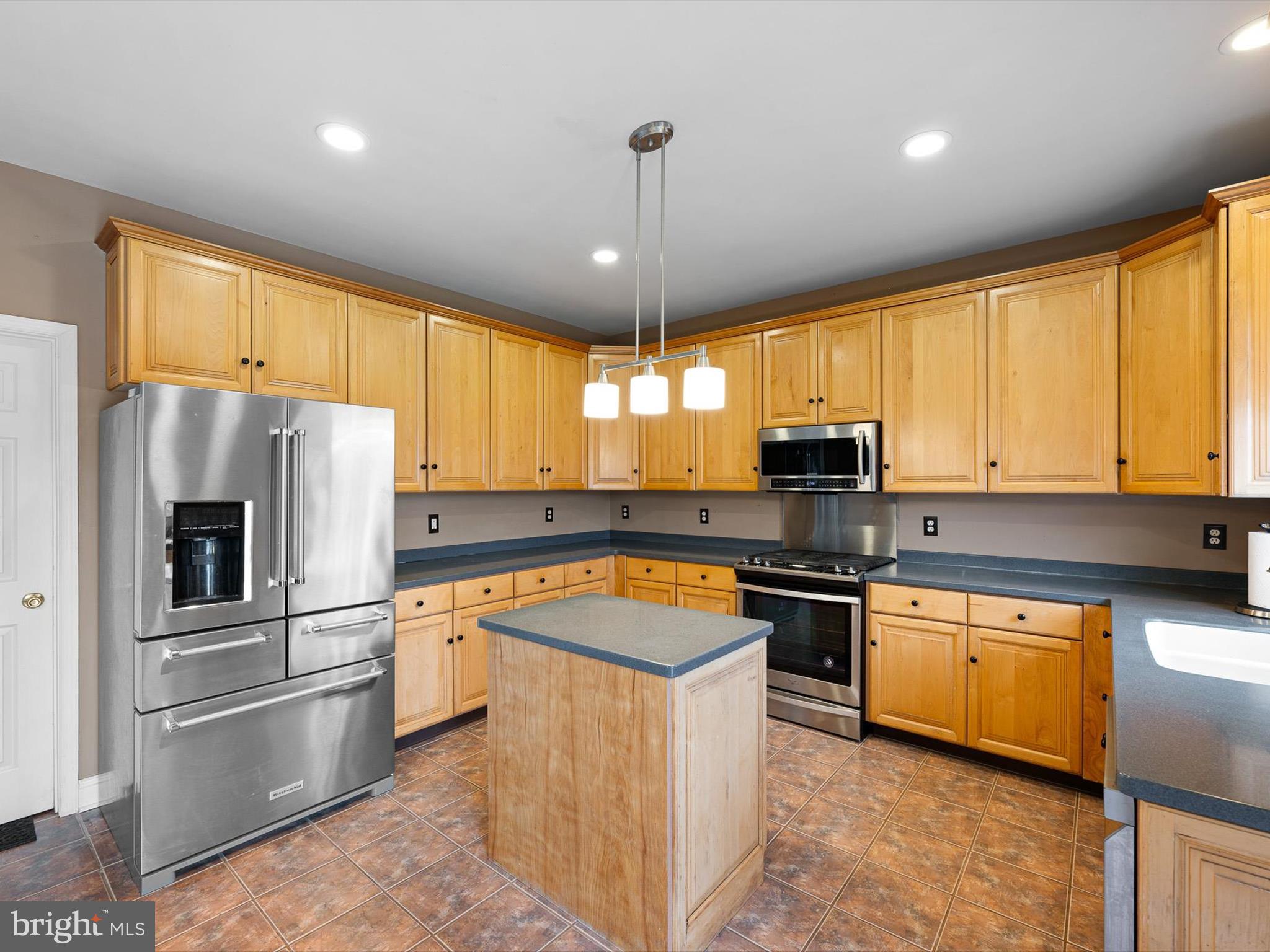109 Chestnut Ridge Drive Magnolia, DE 19962 - Photo 11 of 44 a kitchen with stainless steel appliances granite countertop a sink a stove and a refrigerator