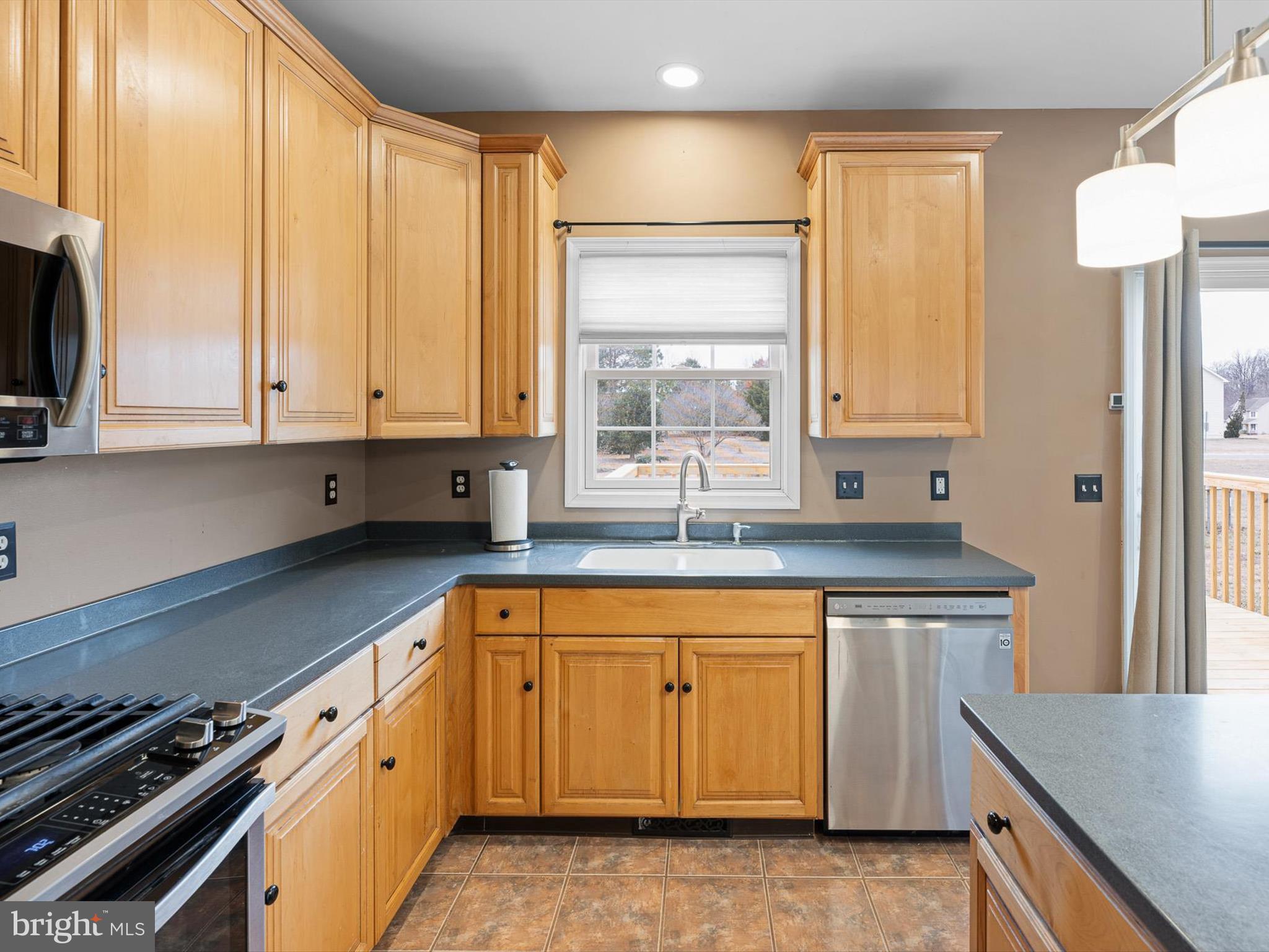 109 Chestnut Ridge Drive Magnolia, DE 19962 - Photo 13 of 44 a kitchen with stainless steel appliances granite countertop a sink a stove and a refrigerator