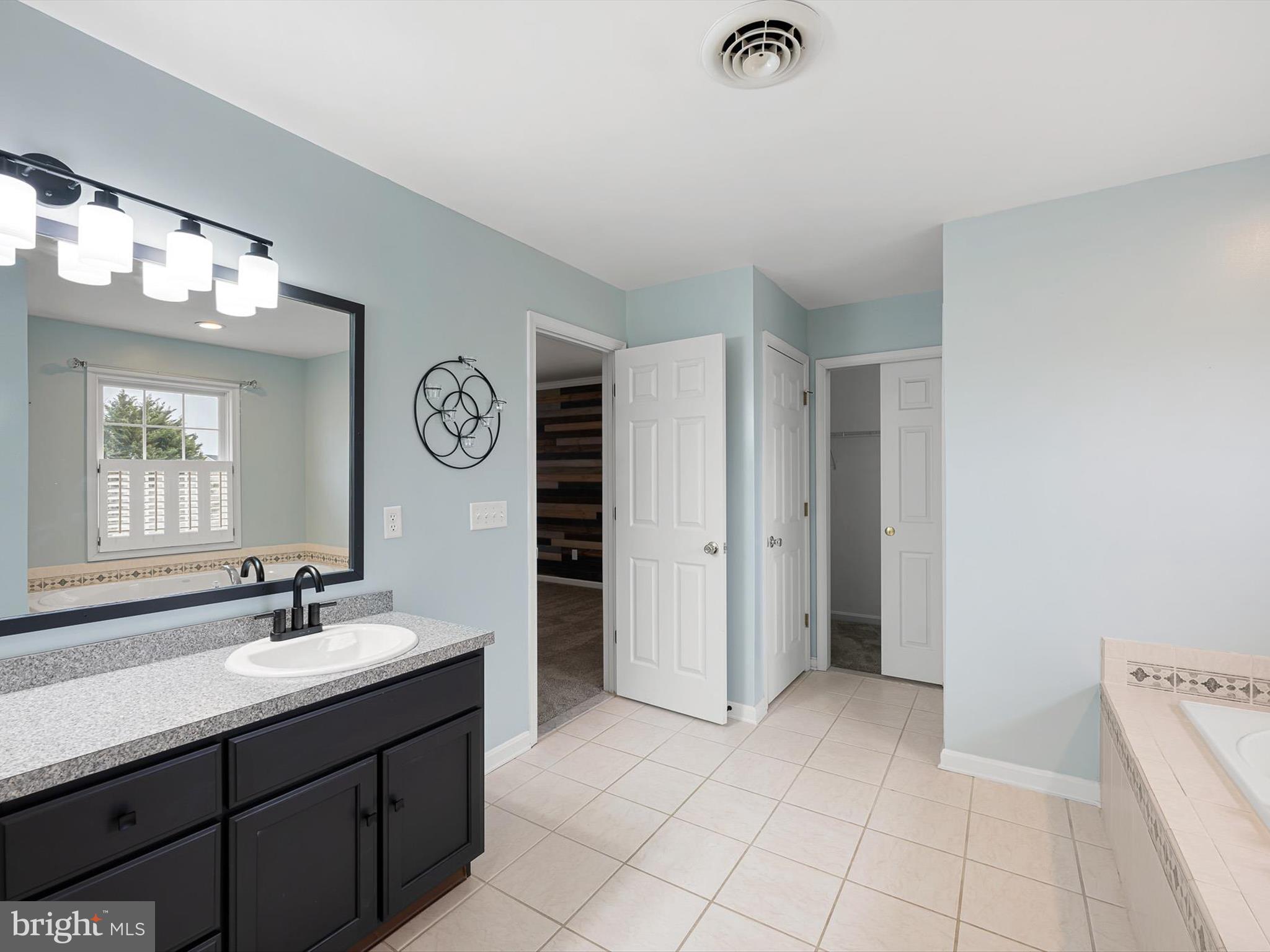 109 Chestnut Ridge Drive Magnolia, DE 19962 - Photo 28 of 44 a spacious bathroom with a double vanity sink and a mirror