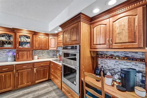 a kitchen with granite countertop cabinets stainless steel appliances and a counter top space