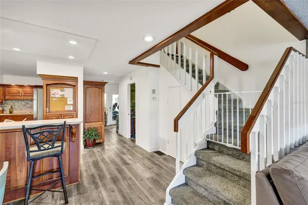 a view of front door dining room with wooden floor and furniture