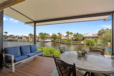 a terrace with outdoor seating and water view