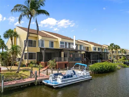 a front view of a house with swimming pool and lake view