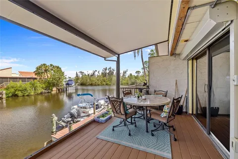 a view of a balcony with chairs and a table