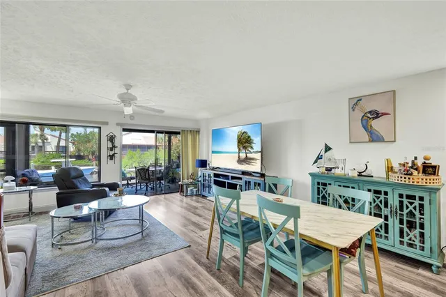 a living room with furniture and a open kitchen view