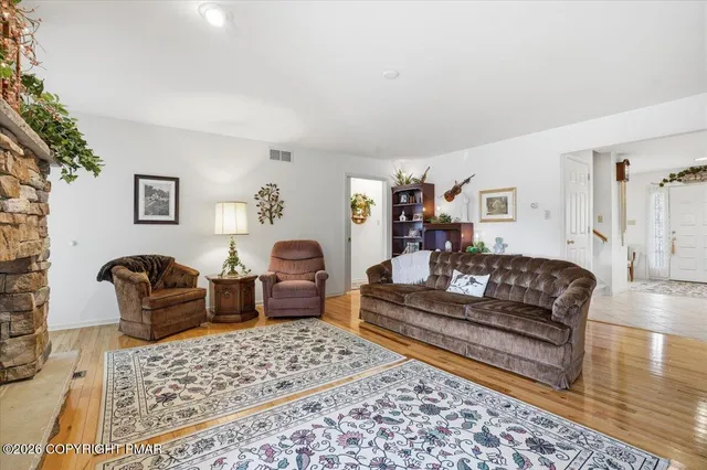a spacious bedroom with two beds and painting on the wall