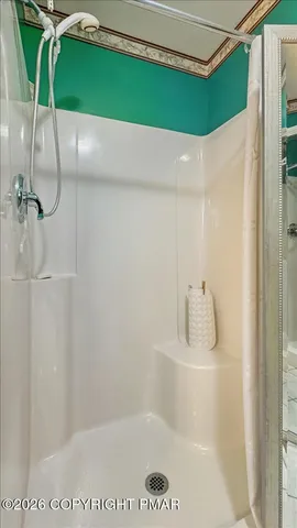 a view of a house with a yard and large tree