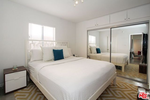 a bedroom with bed and window