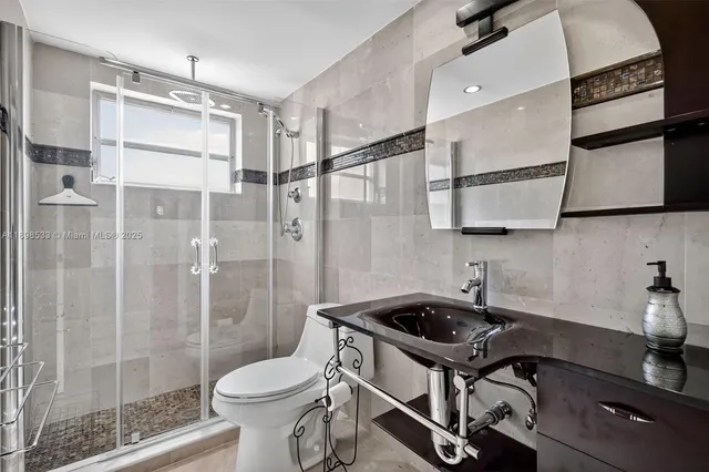 a bathroom with a sink toilet and shower