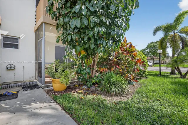a view of a backyard with sitting area
