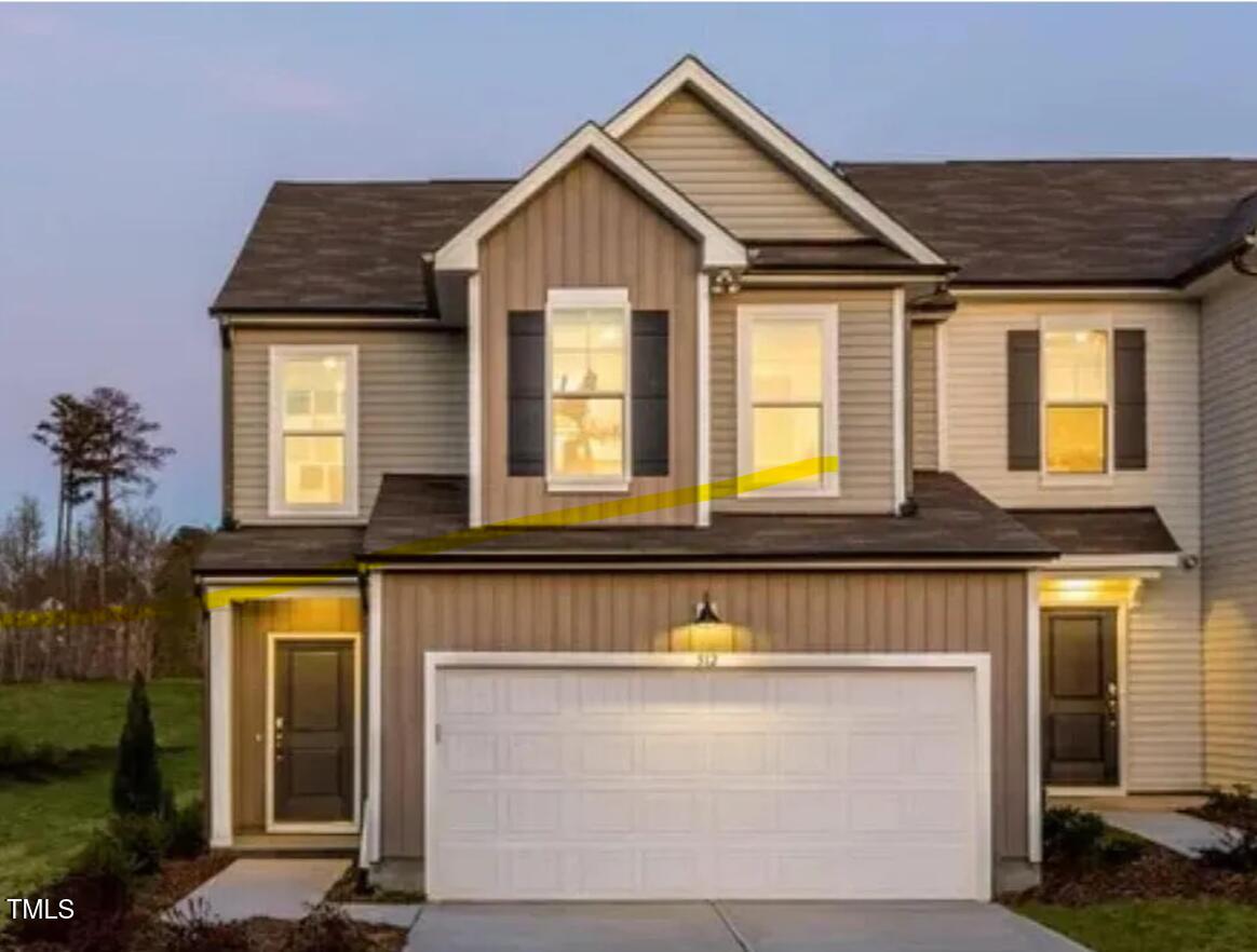 a front view of a house with a garage