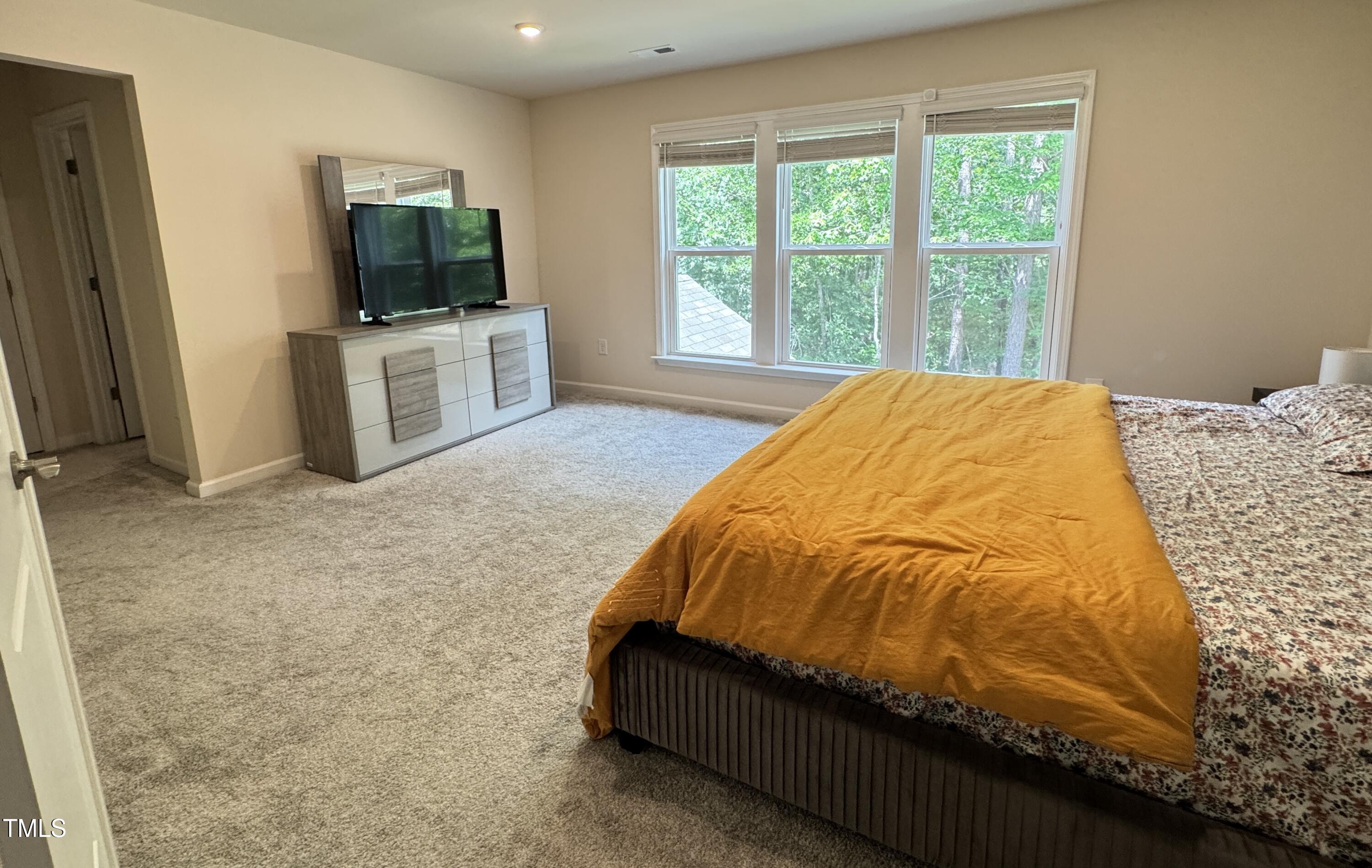 422 Notre Dame Drive Durham, NC 27713 - Photo 14 of 26 a bed sitting in a spacious bedroom next to a window