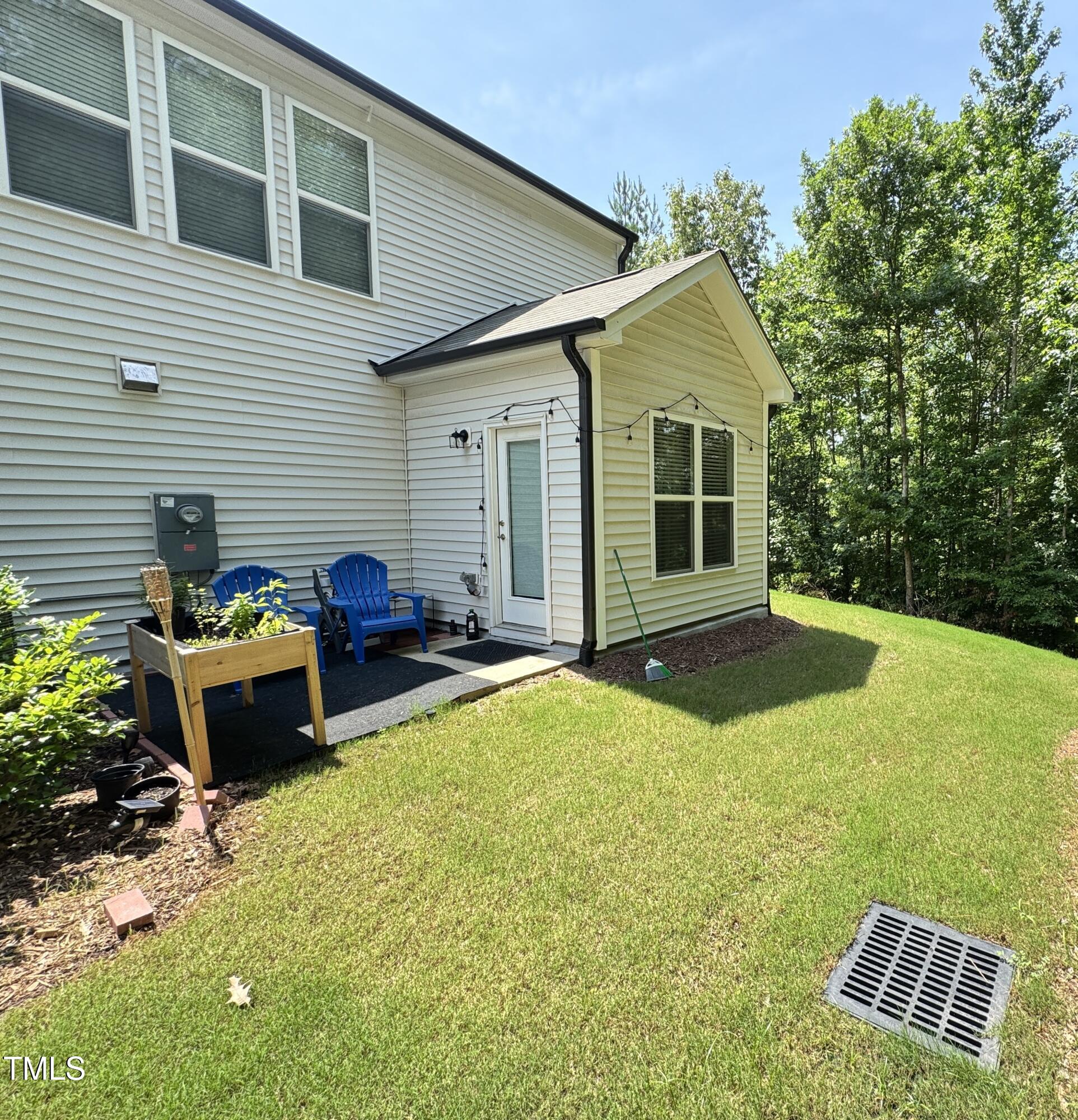 422 Notre Dame Drive Durham, NC 27713 - Photo 24 of 26 a backyard of a house with table and chairs
