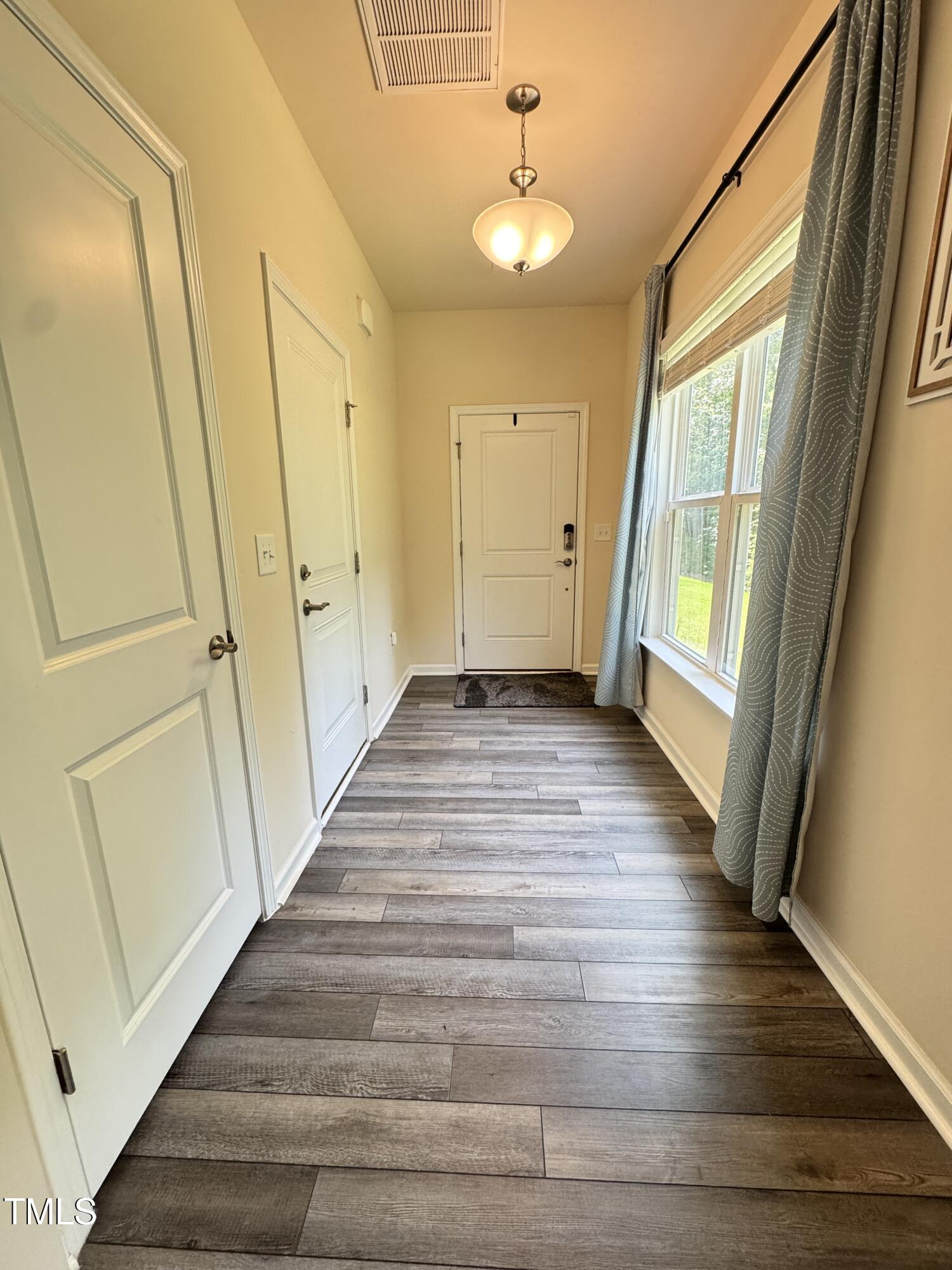422 Notre Dame Drive Durham, NC 27713 - Photo 3 of 26 a view of a hallway with wooden floor and staircase