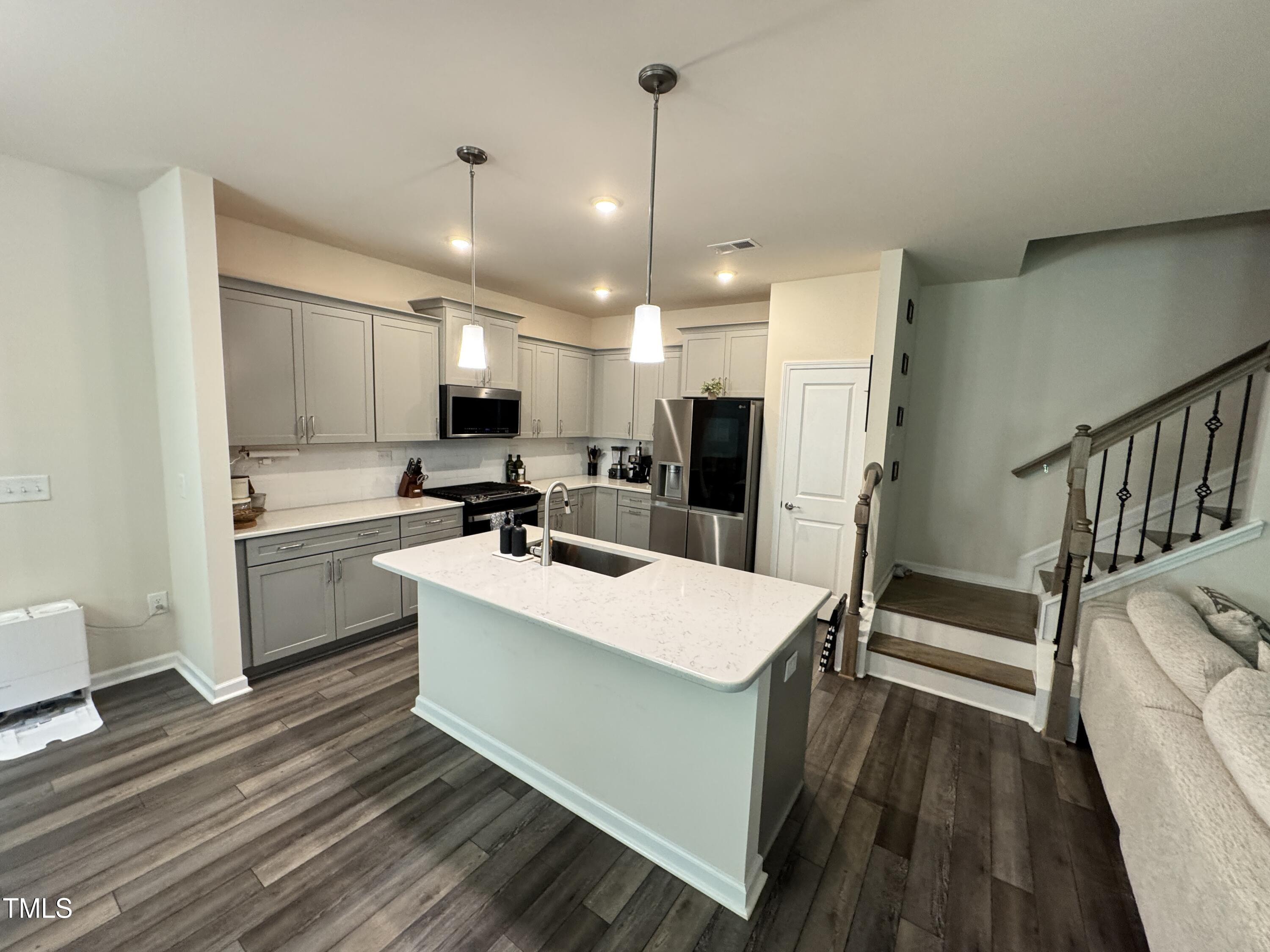 422 Notre Dame Drive Durham, NC 27713 - Photo 8 of 26 a kitchen with a sink stainless steel appliances and white cabinets