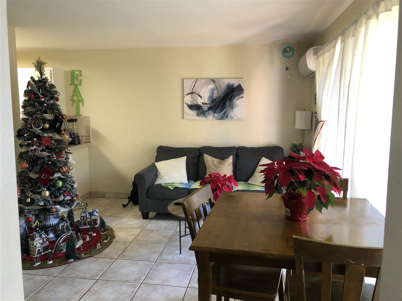 3740 Lower Honoapiilani Road, Unit B103 Lahaina, HI 96761 - Photo 1 of 16 a living room with furniture and flowers
